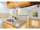 Kitchen view with stone counters, tiled backsplash, and a stainless steel sink at 18 Frances St, Chapel Hill, NC 27517