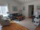 Cozy living room featuring stylish furniture, wood floors and natural light streaming through the windows at 18 Frances St, Chapel Hill, NC 27517