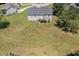 Backyard view featuring a well-maintained yard with a deck, perfect for outdoor entertaining and relaxation at 20 Ingate Way, Louisburg, NC 27549