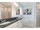 Elegant bathroom featuring dual sinks, granite countertops, a soaking tub, and a separate shower for a spa-like experience at 20 Ingate Way, Louisburg, NC 27549