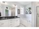 Elegant bathroom featuring dual sinks, granite countertops, a soaking tub, and a separate shower for a spa-like experience at 20 Ingate Way, Louisburg, NC 27549