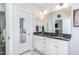 Well-lit bathroom featuring dual sinks, granite countertops, and a spacious layout for a luxurious experience at 20 Ingate Way, Louisburg, NC 27549