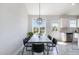 Cozy dining area featuring a rustic wood table, black chairs, and modern pendant lighting at 20 Ingate Way, Louisburg, NC 27549