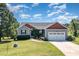 Charming home with well-manicured lawn, landscaping, attached garage and inviting curb appeal at 20 Ingate Way, Louisburg, NC 27549