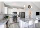 Well-lit kitchen featuring stainless steel appliances, granite countertops, and a convenient island with bar seating at 20 Ingate Way, Louisburg, NC 27549