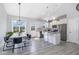 Open kitchen with stainless steel appliances, island with granite counters, and modern finishes at 20 Ingate Way, Louisburg, NC 27549