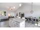 Open concept kitchen featuring a large island with granite countertops, perfect for meal preparation and casual dining at 20 Ingate Way, Louisburg, NC 27549