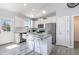 Bright kitchen with white cabinetry, stainless steel appliances, and granite countertops, perfect for cooking and entertaining at 20 Ingate Way, Louisburg, NC 27549