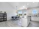 Bright open-concept kitchen with white cabinetry, granite counters, and stainless steel appliances at 20 Ingate Way, Louisburg, NC 27549