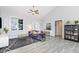 Bright living room featuring a vaulted ceiling and stylish gray flooring at 20 Ingate Way, Louisburg, NC 27549