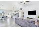Open-concept living room with vaulted ceiling, seamlessly connecting the kitchen and dining area at 20 Ingate Way, Louisburg, NC 27549