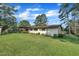 Back exterior of home with large lawn and mature trees at 2003 Ryerson Dr, Garner, NC 27529