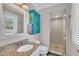 Bathroom boasts granite counters, unique storage, and tile shower with pebble floor at 2003 Ryerson Dr, Garner, NC 27529
