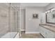Bathroom featuring granite vanity, glass shower door, tile surround, and neutral paint at 2003 Ryerson Dr, Garner, NC 27529