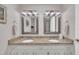 Bright bathroom boasting double sinks, granite counters, updated mirrors, and white cabinets at 2003 Ryerson Dr, Garner, NC 27529