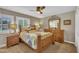 Cozy bedroom with hardwood furniture, soft lighting, and two large windows at 2003 Ryerson Dr, Garner, NC 27529