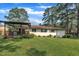 Back exterior of home with large patio and lush lawn at 2003 Ryerson Dr, Garner, NC 27529