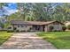 Charming brick home with well-manicured lawn and mature trees, inviting curb appeal and a welcoming atmosphere at 2003 Ryerson Dr, Garner, NC 27529