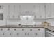 Kitchen sink area with stainless steel appliances, granite counters, and white cabinets at 2003 Ryerson Dr, Garner, NC 27529