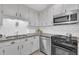 Bright kitchen featuring stainless appliances, granite counters, and white subway tile at 2003 Ryerson Dr, Garner, NC 27529
