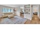 Cozy living room featuring hardwood floors, a stylish sofa, and built-in shelving for a comfortable, organized space at 2003 Ryerson Dr, Garner, NC 27529