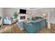 Stylish living room boasts a brick fireplace, hardwood floors, and modern decor, creating a cozy and chic atmosphere at 2003 Ryerson Dr, Garner, NC 27529