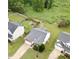 An aerial view showcasing the home, spacious backyard with fenced yard, and mature trees at 2012 Summer Shire Way, Raleigh, NC 27604