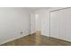 Bedroom with neutral walls, wood flooring, and a double door closet at 2012 Summer Shire Way, Raleigh, NC 27604