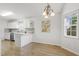 Charming dining area with bay window, chandelier, and breakfast bar at 2012 Summer Shire Way, Raleigh, NC 27604