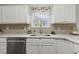 Beautiful kitchen featuring white cabinets, tiled backsplash, and natural light at 2012 Summer Shire Way, Raleigh, NC 27604