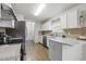 Well-equipped kitchen with white cabinets, stainless appliances, and lots of counter space at 2012 Summer Shire Way, Raleigh, NC 27604