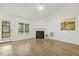 Bright living room with fireplace, ceiling fan, wood-look flooring, and back patio access at 2012 Summer Shire Way, Raleigh, NC 27604