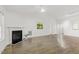 Bright living room with a fireplace, ceiling fan, and wood-look flooring at 2012 Summer Shire Way, Raleigh, NC 27604