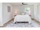 Cozy bedroom with a queen bed, ceiling fan, and patterned rug at 2014 Athens Ave, Durham, NC 27707
