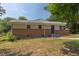 Charming single-story home with a brick facade, neutral siding, and a welcoming blue front door at 2014 Athens Ave, Durham, NC 27707