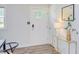Bright foyer featuring a white front door, modern decor, and wood-look flooring at 2014 Athens Ave, Durham, NC 27707
