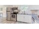 Updated kitchen features stainless steel appliances, white cabinets, and granite countertops at 2014 Athens Ave, Durham, NC 27707