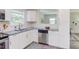 Bright kitchen features white cabinets, stainless steel appliances, and granite countertops at 2014 Athens Ave, Durham, NC 27707