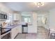 Stylish kitchen boasts white cabinets, granite counters, stainless appliances, and wood-look flooring at 2014 Athens Ave, Durham, NC 27707