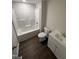 Bright bathroom featuring a tub and shower combination, toilet, and single sink vanity at 203 Hope St, Erwin, NC 28339