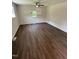Bright, empty bedroom showcasing a ceiling fan, a window, and vinyl flooring at 203 Hope St, Erwin, NC 28339