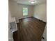 Bedroom featuring window, neutral paint and modern vinyl flooring at 203 Hope St, Erwin, NC 28339