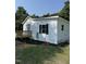 Rear exterior shot of a home with white siding, black shutters, and a wooden deck at 203 Hope St, Erwin, NC 28339