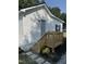 Side exterior with white siding, black shutters, and wooden deck and steps at 203 Hope St, Erwin, NC 28339