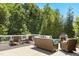 This back deck features nice outdoor furniture around a fireplace at 205 Aurora Rd, Hillsborough, NC 27278
