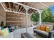 This relaxing back porch includes ample seating and string lights at 205 Aurora Rd, Hillsborough, NC 27278