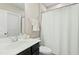 This bathroom offers a sleek single vanity and shower with curtain at 205 Aurora Rd, Hillsborough, NC 27278