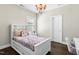 Cozy bedroom with a decorative chandelier, natural light and wood floors at 205 Aurora Rd, Hillsborough, NC 27278