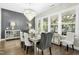 Dining room featuring a modern chandelier, decorative cabinet, and lots of natural light at 205 Aurora Rd, Hillsborough, NC 27278