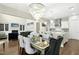 Open dining area featuring a chandelier and comfortable seating with views to the kitchen and living room at 205 Aurora Rd, Hillsborough, NC 27278